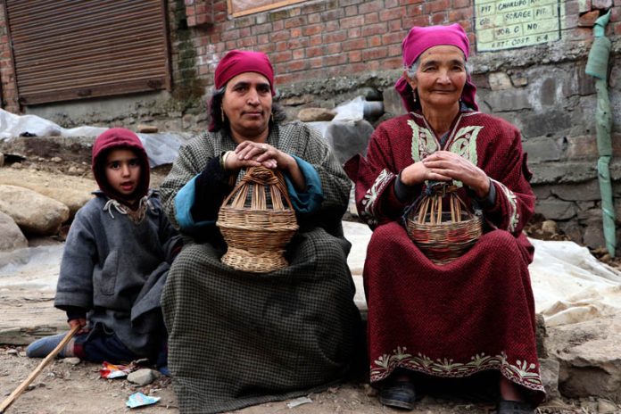 Two elderly women trying to get warmth with the fire pot in a South Kashmir village as the cold conditions intensified across Kashmir on Tuesday. (UNI) Two elderly women trying to get warmth with the fire pot in a South Kashmir village as the cold conditions intensified across Kashmir on Tuesday. (UNI)
