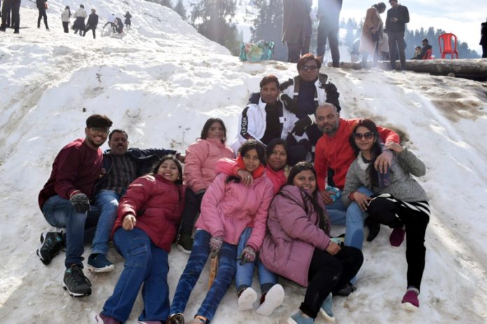 Tourists enjoy snow at Guldanda, Bhaderwah. -Excelsior/Tilak Raj