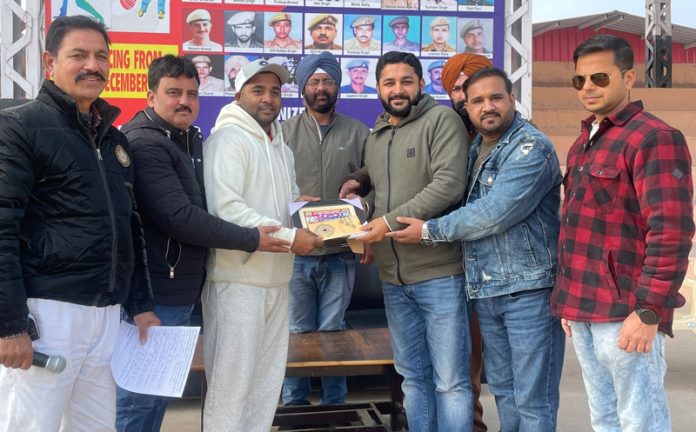 Dignitaries presenting memento to player at Kathua.