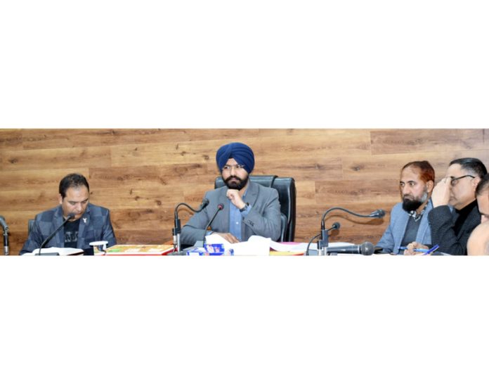 DC Harvinder Singh chairing meeting at Doda on Monday.