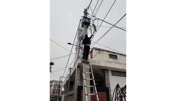 JPDCL officials in action against the illegal power connections in Jammu on Wednesday.