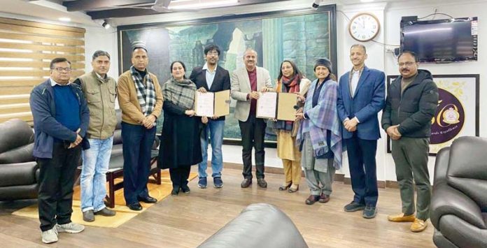 JU Registrar and Director of M/s Growbyte IT Providers Pvt Ltd, Hyderabad displaying copies of MoU signed by them on Friday.