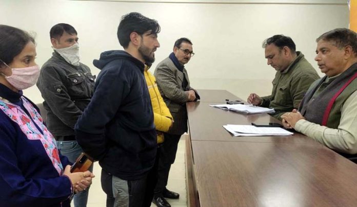 Former Minister, Sat Sharma listening public grievances at BJP Office Jammu on Wednesday.