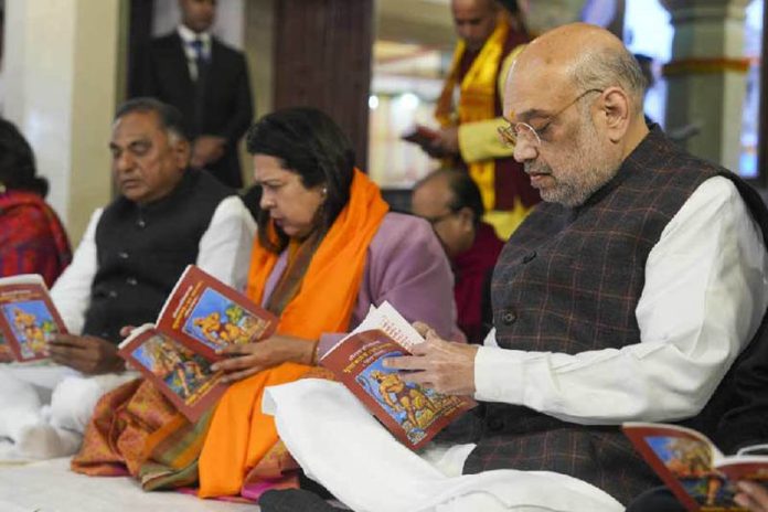 Union Home Minister Amit Shah with Union MoS for Culture Meenakashi Lekhi offers prayers at Laxmi Narayan Temple (Birla Mandir) ahead of the consecration ceremony of Ayodhya's Ram Mandir, in New Delhi, Monday.