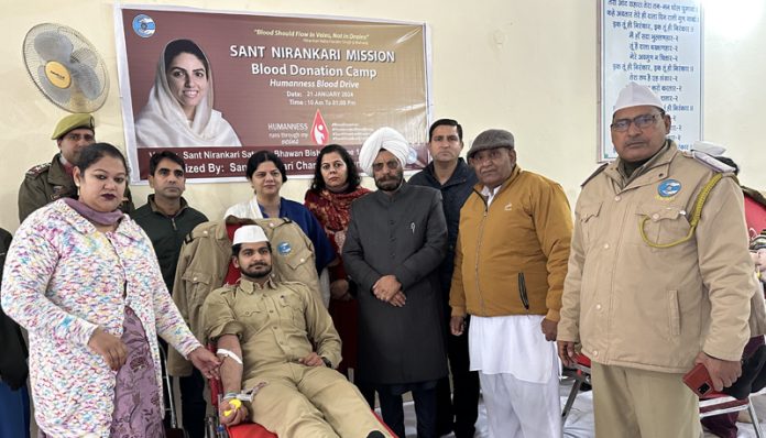 A volunteer donating his blood during a camp at Bishnah on Sunday.