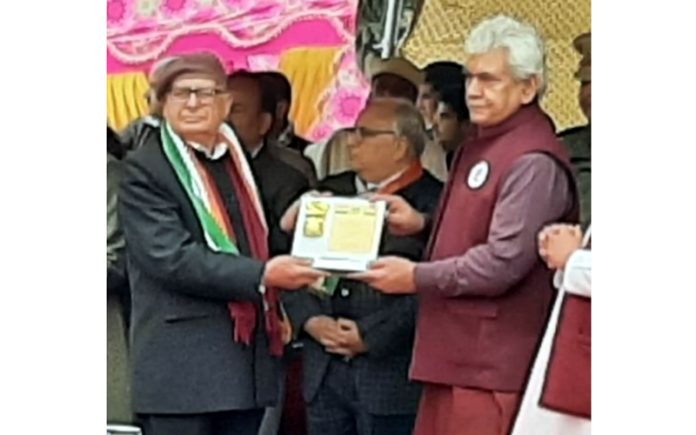 LG Manoj Sinha gives certificate to veteran trade unionist, Abdul Hafeez Fani in Jammu on Tuesday.