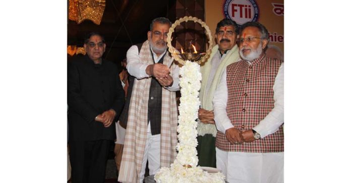 Sunil Singhi, Chairman of the National Traders Welfare Board (NTWB) lighting lamp during a programme in Jammu. -Excelsior/Rakesh