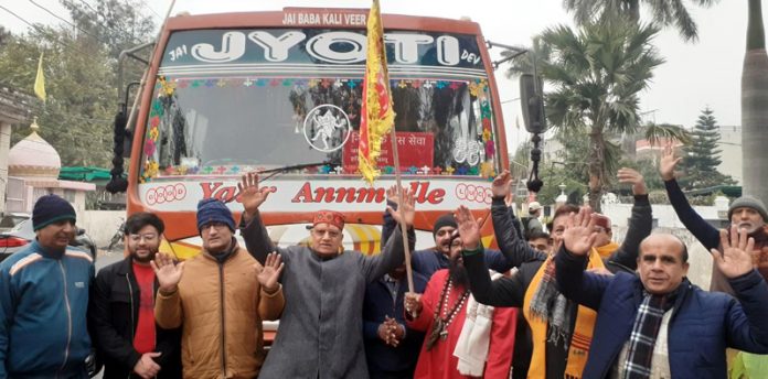 Pawan Shastri flagging off bus to Haridwar on Tuesday.