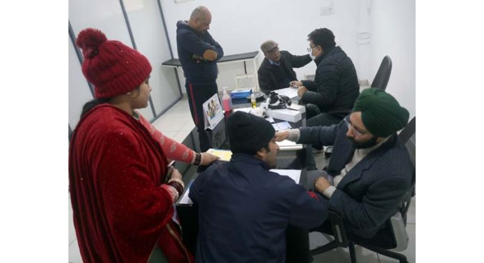 Doctors examining patients during a mega health camp organized by Sure Diagnostic Specialized Lab at Rail Head Complex, Jammu. -Excelsior/Rakesh