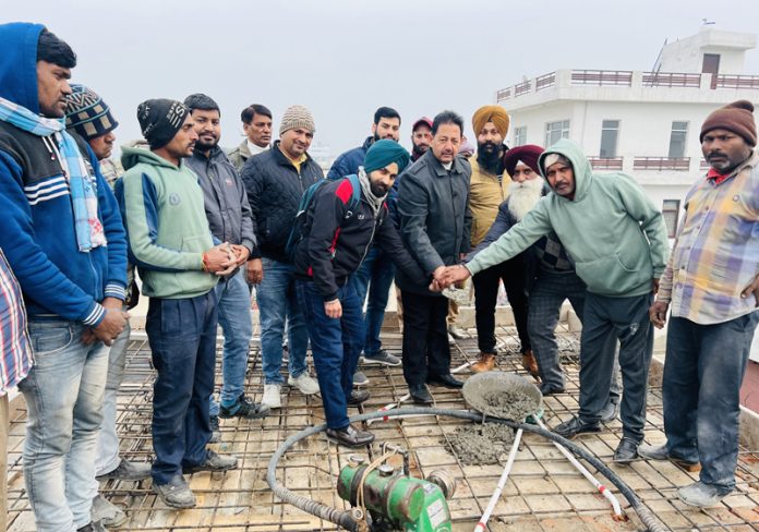 Baldev Singh Billawaria, former Dy Mayor kick starting slab work of community hall at Gangyal on Saturday.