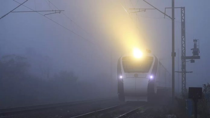 A Vande Bharat Express train runs amid fog on a cold winter morning, in Jammu.