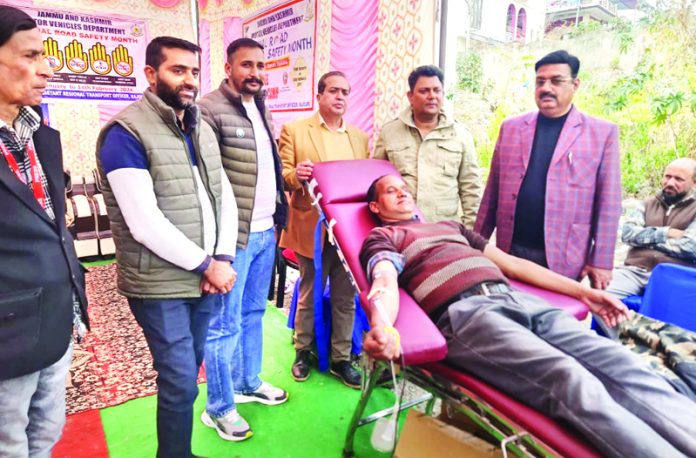 An employee donating blood during blood donation camp being held at ARTO office in Rajouri on Monday. -Excelsior/ Imran