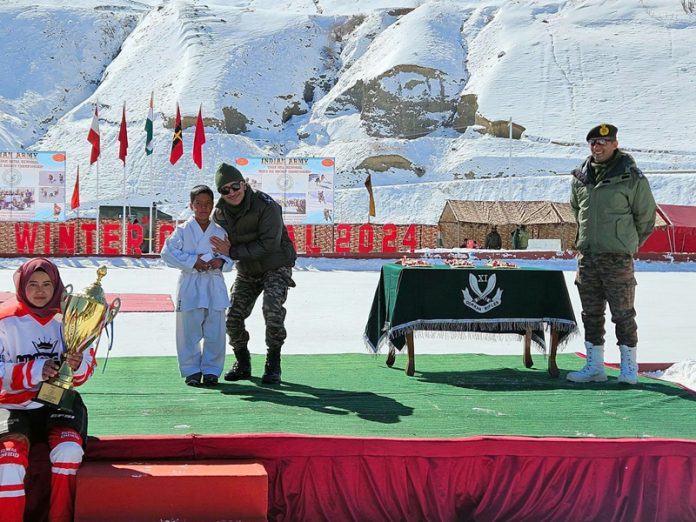 An Army officer posing with players during Drass Winter Carnival 2024 on Tuesday. -Excelsior/Basharat Ladakhi An Army officer posing with players during Drass Winter Carnival 2024 on Tuesday. -Excelsior/Basharat Ladakhi