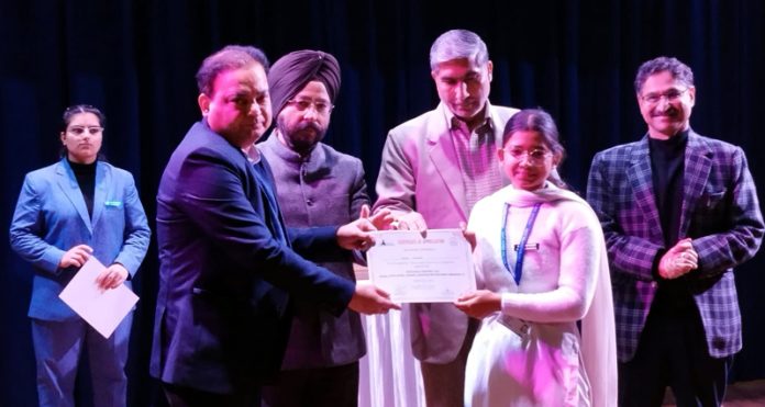 Secretary Transport Niraj Kumar presenting certificate to a student during a programme at GCW Gandhi Nagar, Jammu.