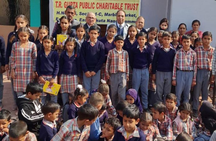 Members of TRG Trust along with teachers and students of Govt School in Rajouri on Sunday.