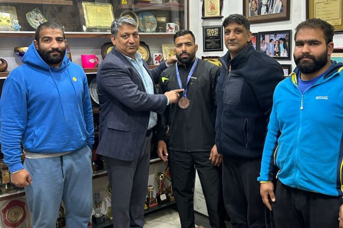 Former International Wrestler and SSP, J&K Police Dushyant Sharma felicitating wrestler Munir Ahmad for winning Bronze medal at National Championship. Former International Wrestler and SSP, J&K Police Dushyant Sharma felicitating wrestler Munir Ahmad for winning Bronze medal at National Championship.