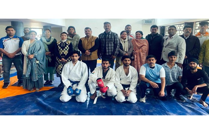 Karate athletes posing with dignitaries.
