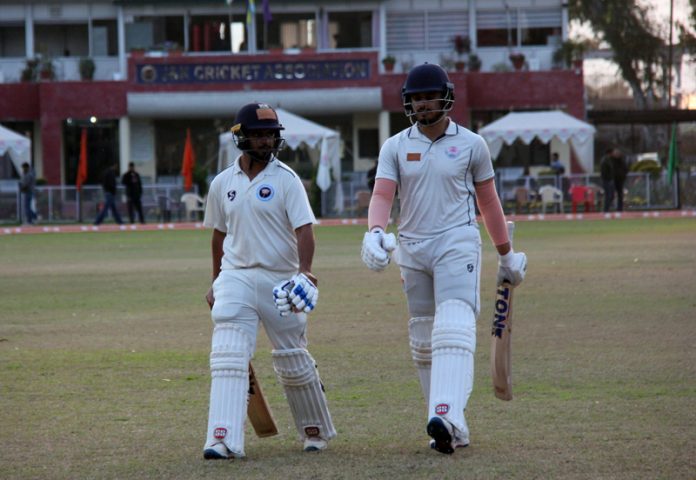 Batsmen moving towards pavilion on first day of Cricket match between J&K and Uttarakhand.