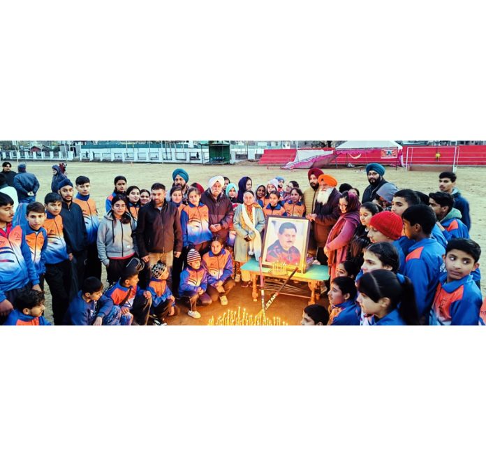 Players, dignitaries and family members of Hockey Coach Late Sham Lal Sharma posing during an exhibition match between Sham Lal Hockey Club and Khelo India Hockey Centre Poonch at Synthetic Hockey AstroTurf Poonch on Monday.