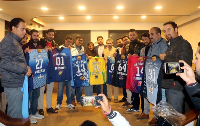 Captains posing with team jersey.