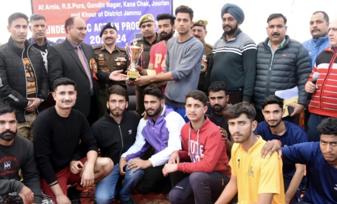 Volleyball team winner captain receiving trophy while posing with dignitaries during a tournament at Akhnoor on Saturday. Volleyball team winner captain receiving trophy while posing with dignitaries during a tournament at Akhnoor on Saturday.