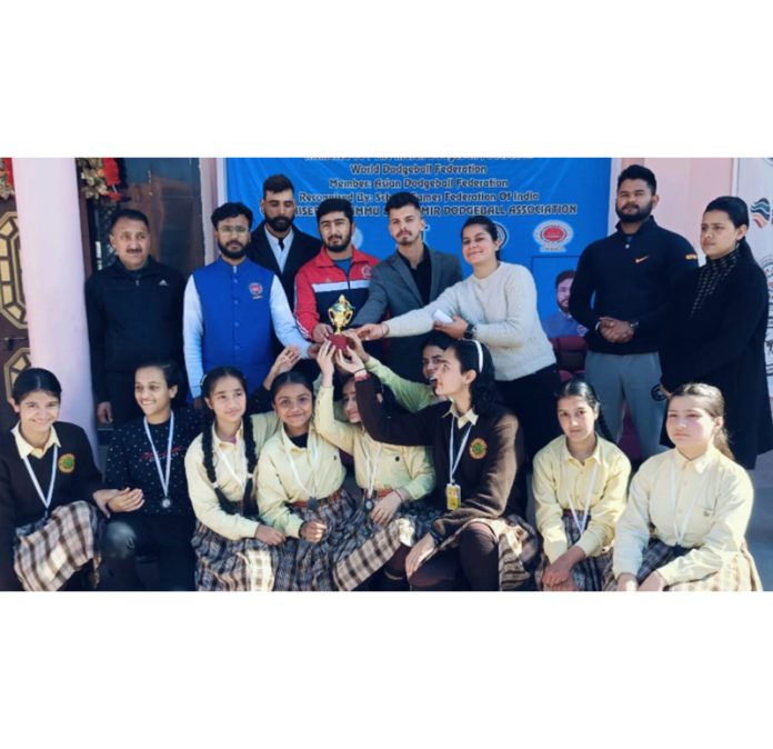 Dodgeball players posing with trophy during a championship at Jammu.