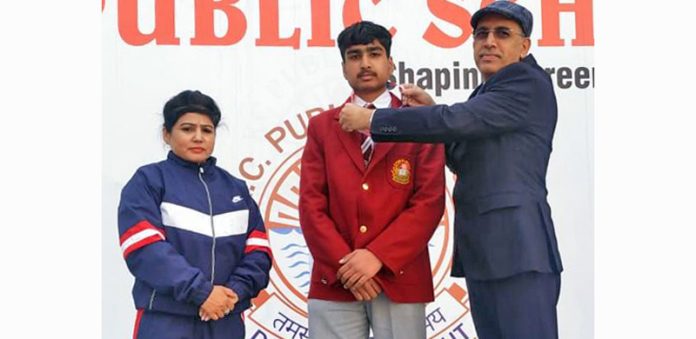 Students of KC Publis School posing with school management.