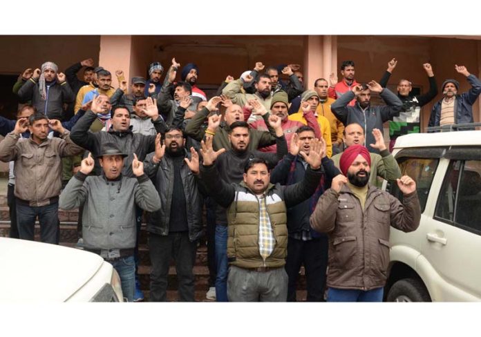 PHE workers staging protest dharna outside Chief Engg's office at B C Road in Jammu on Monday. -Excelsior/ Rakesh