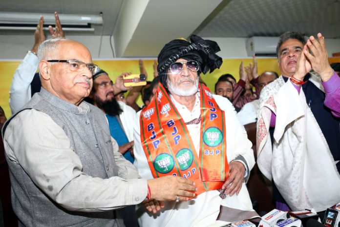 Senior NC leader and former Minister Mushtaq Ahmed Bukhari being taken into party fold with his supporters at BJP Office by party president , Ravinder Raina and general secretary (org), Ashok Koul at Jammu on Thursday. -Excelsior/Rakesh
