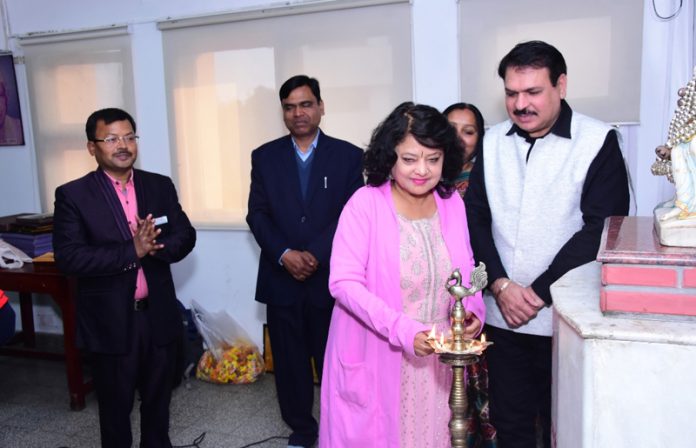 Anila Singh Charak lighting ceremonial lamp during the function.