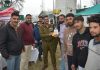Senior police officer presenting trophy to winning team at Anantnag.