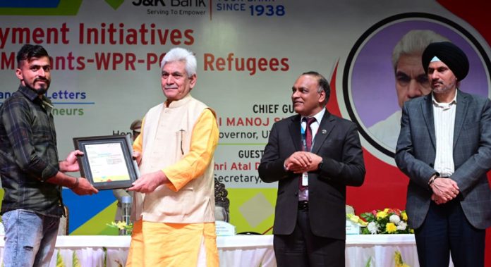 LG Manoj Sinha handing over letter to a youth.