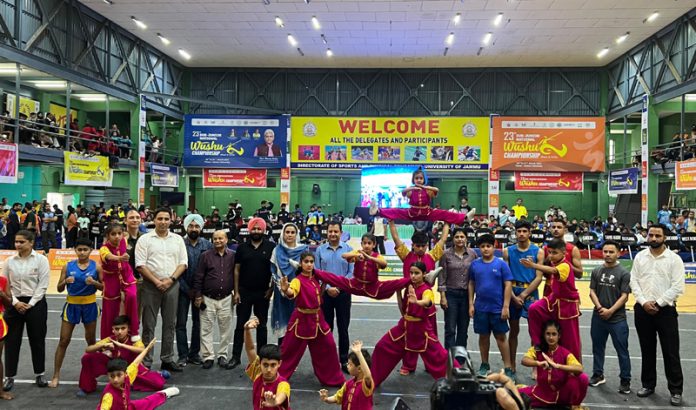 Wushu athletes in action while posing with Nuzhat Gull, Secretary J&K Sports Council during inaugural ceremony at Jammu University.