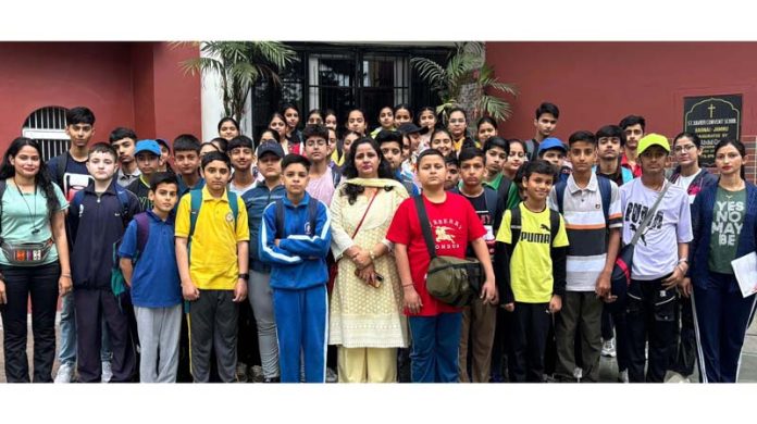 A group of students, teachers posing for a group photograph during a short trek expedition.