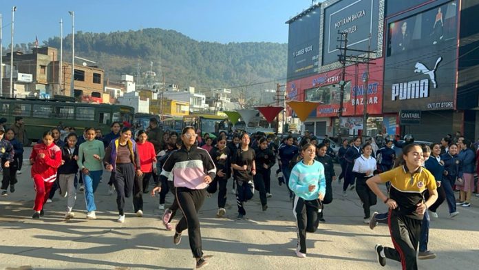Large number of female participants taking part in half marathon at Udhampur.