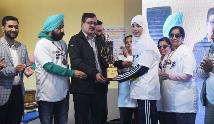 A Runner receiving trophy during JITO Ahimsa Run at Srinagar on Sunday. A Runner receiving trophy during JITO Ahimsa Run at Srinagar on Sunday.