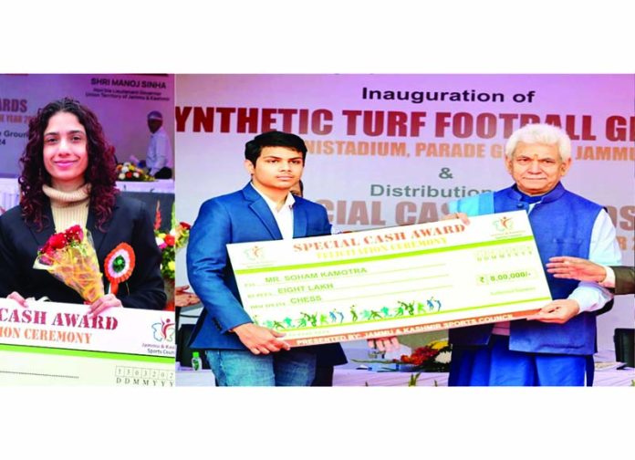 Shreya Gupta receiving cheque of Rs 1 lakh and Sohan Kamotra Rs 8 lakh from LG Manoj Sinha at Parade Ground, Jammu on Wednesday.