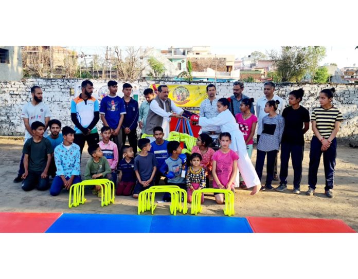 Members of Sahaj Nath Club Purkhoo receiving sports material.