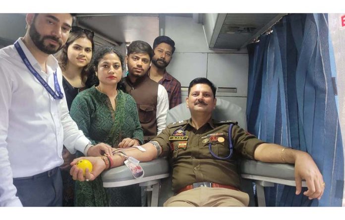 SP South Ajay Sharma donating blood during a camp organised by ABVP at University of Jammu on Friday. SP South Ajay Sharma donating blood during a camp organised by ABVP at University of Jammu on Friday.