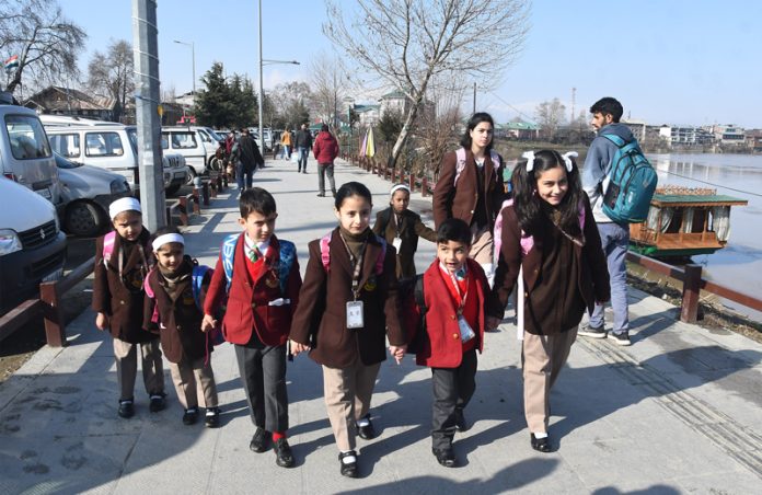 Students going to school after three months winter break in Srinagar on Monday. — Excelsior / Shakeel Students going to school after three months winter break in Srinagar on Monday. — Excelsior / Shakeel