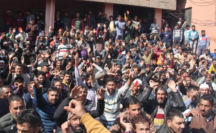 PHE workers staging protest dharna outside Chief Engg's office at BC Road in Jammu on Monday. — Excelsior/Rakesh