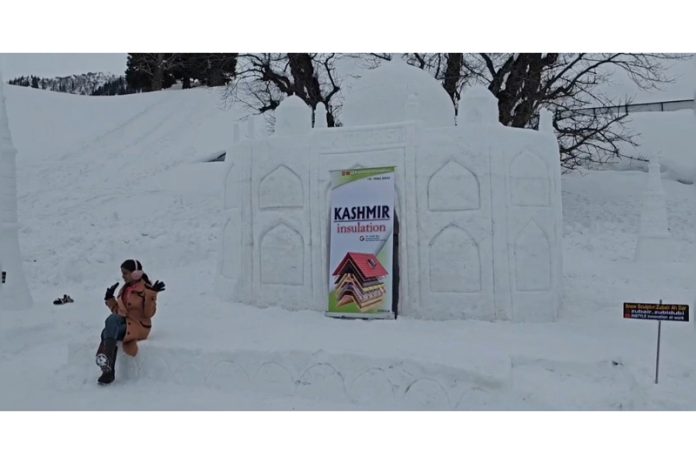 A tourist posing with Snow Taj Mahal. —Excelsior/Firdous