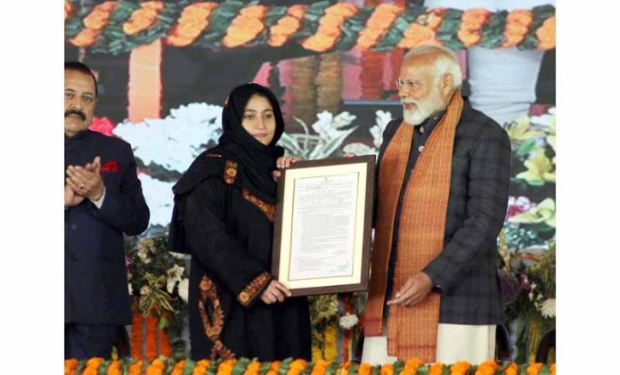 Prime Minister Narendra Modi handing over appointment letter to a girl at Bakshi Stadium in Srinagar.