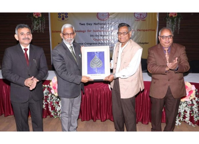 Cluster University VC presenting memento to guest during conference. Cluster University VC presenting memento to guest during conference.