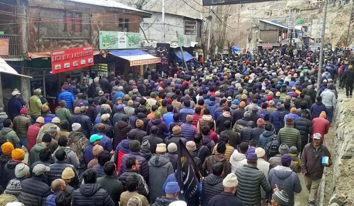 Mourners participating in funeral procession of renowned religious leader Sheikh Mohd Ibrahim Khalili in Kargil. -Excelsior/Basharat Ladakhi