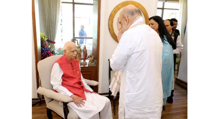 Union Home Minister Amit Shah greets veteran BJP leader L K Advani before the latter was honoured with the 'Bharat Ratna' at his residence in New Delhi. Union Home Minister Amit Shah greets veteran BJP leader L K Advani before the latter was honoured with the 'Bharat Ratna' at his residence in New Delhi.