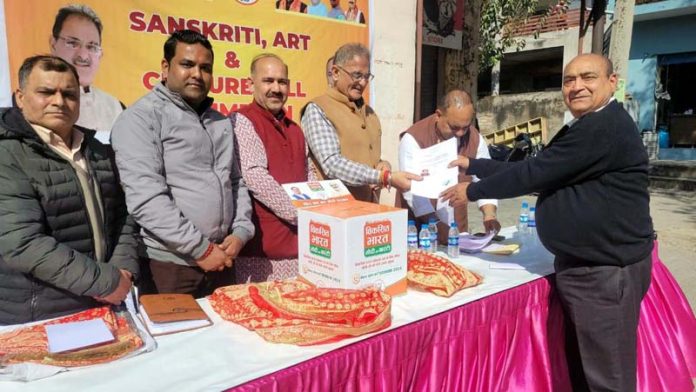 Former Dy CM and senior BJP leader, Kavinder Gupta handing over domicile certificates to beneficiaries at a function at Channi on Sunday.