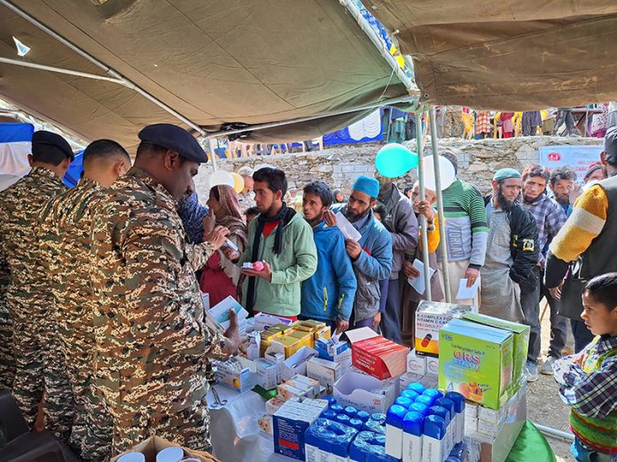Villagers queue-up at a medical camp organised by CRPF at a village in Doda on Monday. -Excelsior/Tilak Raj