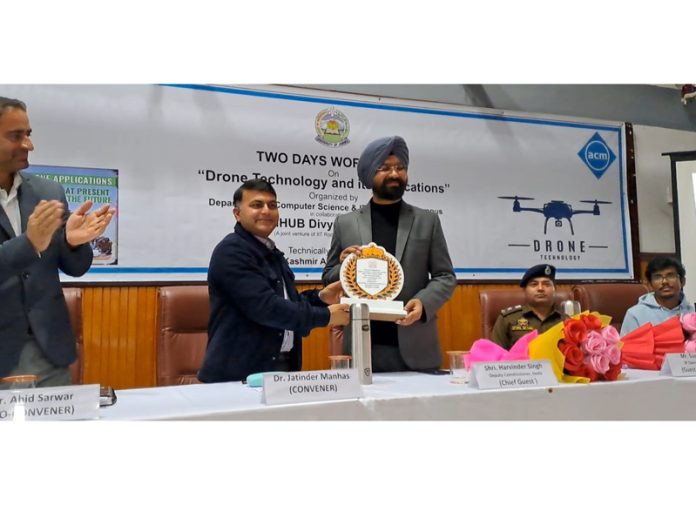 Dr Jatinder Manhas greeting DC Doda, Harvinder Singh, with a memento during a workshop in JU's Bhaderwah campus on Friday.