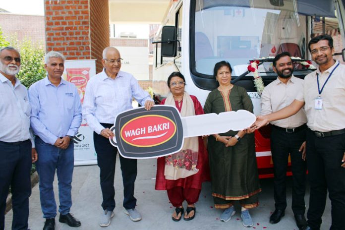 Raseshbhai Desai, MD, Wagh Bakri Tea Group donating a blood collection van to Muni Seva Ashram on Thursday.